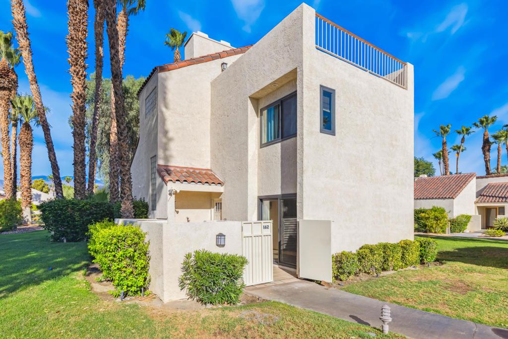 Welcome to your dream home in the heart of the prestigious Mission Hills Country Club. This beautifully updated 2-bedroom, 2-bathroom condo blends modern luxury with serene desert charm, offering the perfect escape for full-time living or a weekend getaway. From the moment you step inside, you're greeted by vaulted ceilings, fresh paint, and sunlight pouring through brand-new windows and sliders, creating a bright and cheerful ambiance. The open-concept living area features tile flooring, a cozy gas fireplace, and clean architectural lines--all designed to complement the stunning panoramic mountain views. Enjoy the flexibility of two spacious en-suite bedrooms, one upstairs and one down--ideal for guests, a home office, or multi-generational living. The updated kitchen boasts quartz countertops, all-new stainless steel appliances, custom cabinetry, a pantry, and a dedicated coffee station. A striking custom wood bar with vibrant accents adds a perfect touch for entertaining.Outdoor living is just as impressive, with private rear patio perfect for morning coffee or evening BBQs, and a rooftop terrace offering spectacular sunset and mountain views. A detached 2-car garage with a newer door add to the home's appeal. Upgrades include: Tankless water heater; Newer windows throughout; Tile flooring and carpeting on the stairs; Updated bathrooms & Kitchen; Fresh interior paint. Located just steps from the community pool and spa, and offering access to five pools/spas, this home provides the best of resort-style living. Mission Hills Country Club offers award-winning golf, tennis, fitness facilities, a clubhouse, and 24-hour guard-gated security. This isn't just a home--it's a fresh start in a community that offers the ultimate blend of luxury, comfort, and tranquility. All information deemed accurate, buyer to verify. Welcome Home!