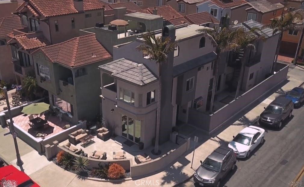 Experience the quintessential California lifestyle in this immaculate beach house located just one block from the sand and surf in the heart of Surf City USA. This exquisitely designed home boasts quality craftsmanship and stunning artwork, creating an unforgettable atmosphere. Situated only a few blocks from downtown and steps from the beach, this property offers an unbeatable location. Within a short 5-minute stroll, you'll find the famous Huntington Beach Pier, an array of exceptional restaurants, lively clubs with live entertainment, and unique shopping experiences. This gorgeous beach house features off-street parking for two vehicles and ample street parking for guests. Enjoy ocean views from the front patio and the rooftop deck, where you can bask in the refreshing ocean breeze each morning. The immaculate interior is tastefully decorated with a blend of modern and contemporary styles, offering ample space to relax and unwind. The home boasts two spacious living rooms, providing the perfect separation to enjoy quiet time. Make memories with your loved ones around the fire pit on the front patio, the ideal spot for happy hour or late-night conversations. Discover the essence of California living in this magnificent beach house and treat yourself to an unforgettable time with your family. Don't miss this unique opportunity to lease this stunning property on a month-to-month basis in the heart of Surf City USA.