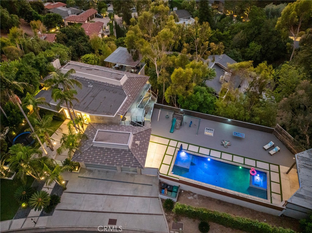 Amazing contemporary Cowan Heights estate on over 1/2 acre lot with booming views via a gated courtyard with mature landscaping. Offering incredible indoor and outdoor space, this North Tustin home is your haven away from the hustle and bustle, yet just minutes away from the excitement of vibrant Orange County. This is your opportunity to secure a luxurious property at a tremendous value per square foot. A large pool and spa area with incredible all day sun is perfect for play and lounging, and includes a shaded zone for those warm summer days. Off the main living and kitchen area is a large, covered view deck open to the ocean breeze. Enjoy sit down hills and city lights views from most rooms. The main home includes AC and 5 bedrooms, 3 full baths and 2 powder baths, plus an office. The 1-bedroom, 1.5 bath guest house is attached via a lock off, yet enjoys it's own private entrance and generous kitchen and living spaces. Open the whole home up and you have a 6 bedroom, 5 bath and 3 powder bath estate perfect for large families, multiple guest rooms, or space for your gym, home offices, art studio or other use as you wish. Nearby is Peter's Canyon Regional Park with hiking and biking trails, as well as neighborhood Bent Tree Park. If you crave views, space, and privacy amidst nature's beauty with fantastic year-round weather, look no further than 10255 Overhill Drive in North Tustin.