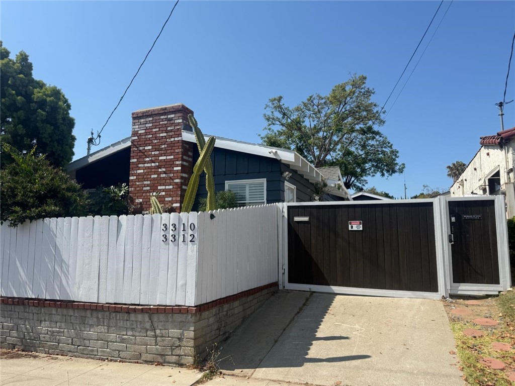 Welcome to 3310 London Street! An inviting, private 2-bedroom, 1-bath Craftsman home in Silver Lake. As you step inside, you're greeted by a spacious living room full of character with vaulted ceilings, a large brick fireplace and vintage window benches for the perfect retreat after a long day's work. A beautifully updated kitchen features stainless-steel appliances, a counter-depth french-door fridge, gas range, as well as a brand new in-unit washer and dryer. Antique wood beams and original hardwood floors carry well-maintained, hundred-year-old charm throughout the home, while spacious closets and original cedar-lined chests provide ample storage for everyday living. What truly sets this home apart is the feeling of relaxation and retreat created by its white-picket fencing and private front and rear yards. Year-round, enjoy hummingbirds and butterflies attracted by blooming bougainvillea, lavender, and flowering cacti surrounding the property. Additional highlights include whisper-quiet central AC for those warmer days, gated front entry for added security, a 24-hour camera system, landscape maintenance for the sustainability-minded garden, and pleasing interiors with thoughtful updates throughout. With Target just a 4-minute walk away, two parks just a hop and skip from home, and the shops and restaurants on Sunset only a 20-minute stroll through shaded neighborhood, you're sure to enjoy the convenience and charm of this sunny Silver Lake home. Water and sewer included.