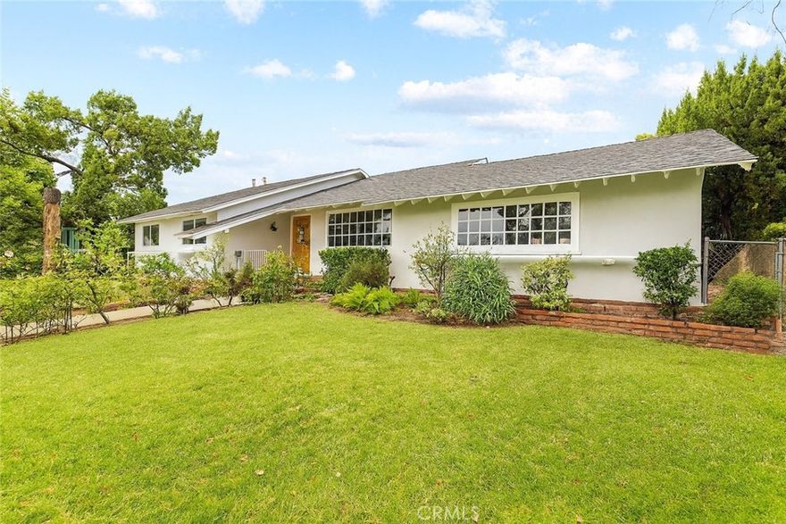 Absolutely gorgeous Porter Ranch pool home with nearly 2,000 sq. ft. of living space on an over 10,000 sq. ft. landscaped lot featuring a pool and RV access. Pride of ownership is evident throughout with hardwood floors, a bright formal dining room with French doors, breakfast bar, and rock fireplace. The spacious family room offers vaulted wood-beamed ceilings, wet bar, French doors, and new laminate flooring. The kitchen includes tiled counters, double oven, cabinetry, and a breakfast nook. The primary suite boasts hardwood floors, ample closets, vanity, and an updated bath, while the secondary bedrooms also feature hardwood floors and ceiling fans. Enjoy the entertainer’s backyard with sparkling pool and spa, large patio, brick BBQ, fruit trees, and covered parking with private entry. Recent upgrades include new roof, windows, recessed lighting, and freshly painted inside and out.