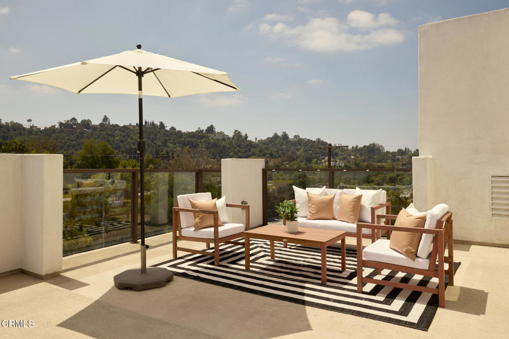 Discover contemporary elegance at 6899 Pollard Street in vibrant Highland Park, Los Angeles. This modern, multi-level residence offers a stylish and functional living space with 3 bedrooms, 3.5 bathrooms, and 1,974 square feet of luxurious design topped off with a massive rooftop deck. Enter at the ground floor which features a coveted first floor bedroom with full bathroom. Continue to the second level with an open concept floor plan, accentuated by floor-to-ceiling windows that flood the space with natural light. A well-appointed kitchen boasts a large island with counter seating, perfect for casual meals or entertaining. Flow seamlessly into the dedicated dining area and the outdoor patio to enjoy our LA weather year round. The third floor features the primary suite with amazing views, ceiling fan, and huge closet. The en suite bathroom has two separate sinks, a soaking tub and large shower. An additional guest bedroom and full bath completes the layout. But don't stop there! Make your way up to the rooftop deck, where sweeping panoramic views set the stage for relaxation and entertainment. Whether you're unwinding with a glass of wine or hosting a lively barbecue with the included grill, this space offers the perfect backdrop for any occasion This home also features high ceilings and wood flooring throughout, ample storage, central air conditioning, washer/dryer conveniently located on the third level, and direct access to the 2-car garage.