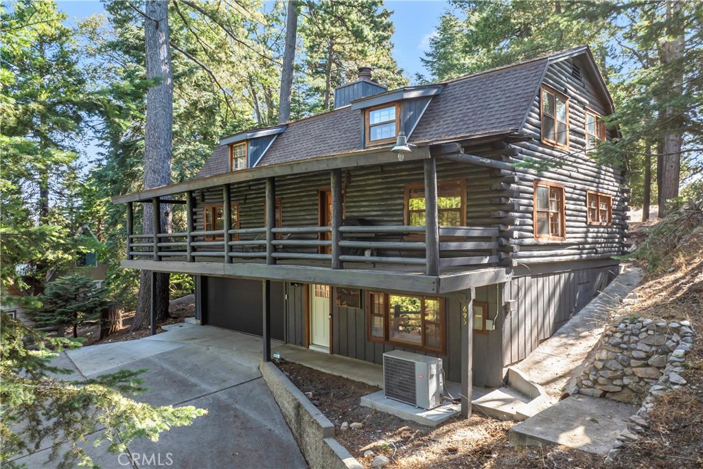 Welcome to Lake Arrowhead! This custom log cabin offers over 2,400 sq. ft. with 3 bedrooms, 2 baths, and an attached garage. The spacious living room features a cozy wood-burning fireplace, while the gourmet kitchen and dining area are perfect for gatherings. A large recreation room adds space for family fun, plus there’s an additional lot for expansion or extra outdoor enjoyment. Just minutes from the Village and the lake, this mountain retreat is full of character and ready for you to make it your own.