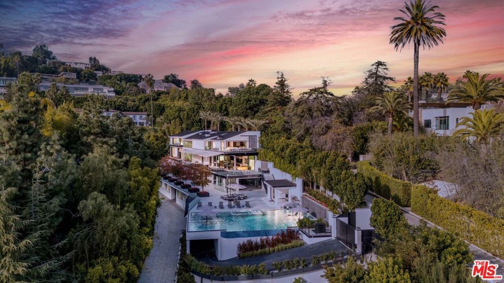 This sleek newly constructed estate boasts extraordinary city views and unrivaled indoor-outdoor entertaining space with an Olympic-sized pool, screening room with 4k D-ILA Precision projector, spa with sauna, incredible sound system, gym, and parking for over 50 cars. Outfitted with top-tier Miele and WOLF appliances, this estate features automated Fleetwood floor-to-ceiling doors, luxurious heated TOTO toilets, and a self-playing Mason & Hamlin piano. Additionally, the gym is equipped with premium Matrix and Hoist machines to support a full range of fitness routines. With 8-foot privacy walls, comprehensive security cameras, sprinkler systems and sensors throughout, this residence also offers both exclusivity and peace of mind. Experience this unparalleled entertainer's estate for yourself!