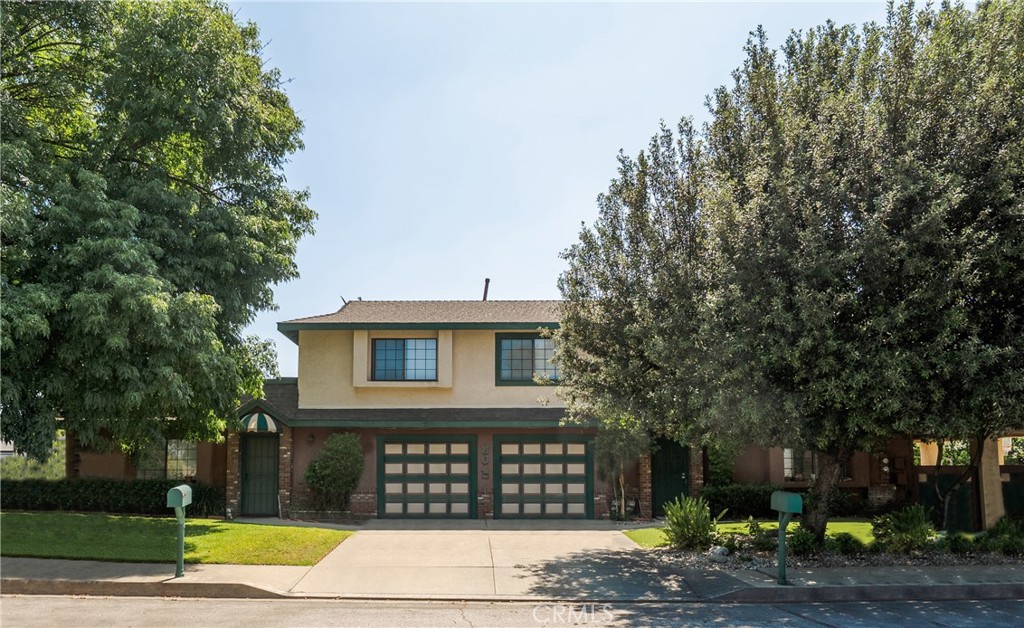 Rarely does a property like this come available in Glendora—just moments from the charm of downtown and nestled on a prime corner lot, this two-story duplex offers versatility, character, and incredible potential. Unit A is approximately 1,200 square feet and features a warm and inviting living room, a kitchen with a cozy dining area, and a private walk-out patio—perfect for relaxing or entertaining. A convenient half bath and indoor laundry area complete the downstairs. Upstairs, you'll find two spacious bedrooms, a full bath, and a rooftop terrace where you can enjoy peaceful mountain views and your morning coffee. This unit also includes a one-car garage with direct access. Unit B is approximately 1,500 square feet and offers even more space with a generous living room, dedicated dining area, and a freshly updated kitchen that opens to a large, covered and enclosed patio for extended indoor-outdoor living. A half bath and laundry area are also located downstairs. Upstairs features three sizable bedrooms, including a spacious primary suite with a private bath and its own veranda. Two additional bedrooms share a full hall bath. This unit also offers a one-car garage with direct access, a driveway parking spot, and a rare bonus—an extra-large side parking area with RV potential. Both units are separately metered for utilities, offering added convenience and flexibility. With beautiful shade trees, a wraparound lawn, and fantastic curb appeal, this well-maintained property is ideal for investors, owner-occupants looking to rent out the other unit, or multi-generational living. Located in a highly sought-after school district and one of the most desirable towns in the San Gabriel Valley, this is a rare opportunity you won’t want to miss.