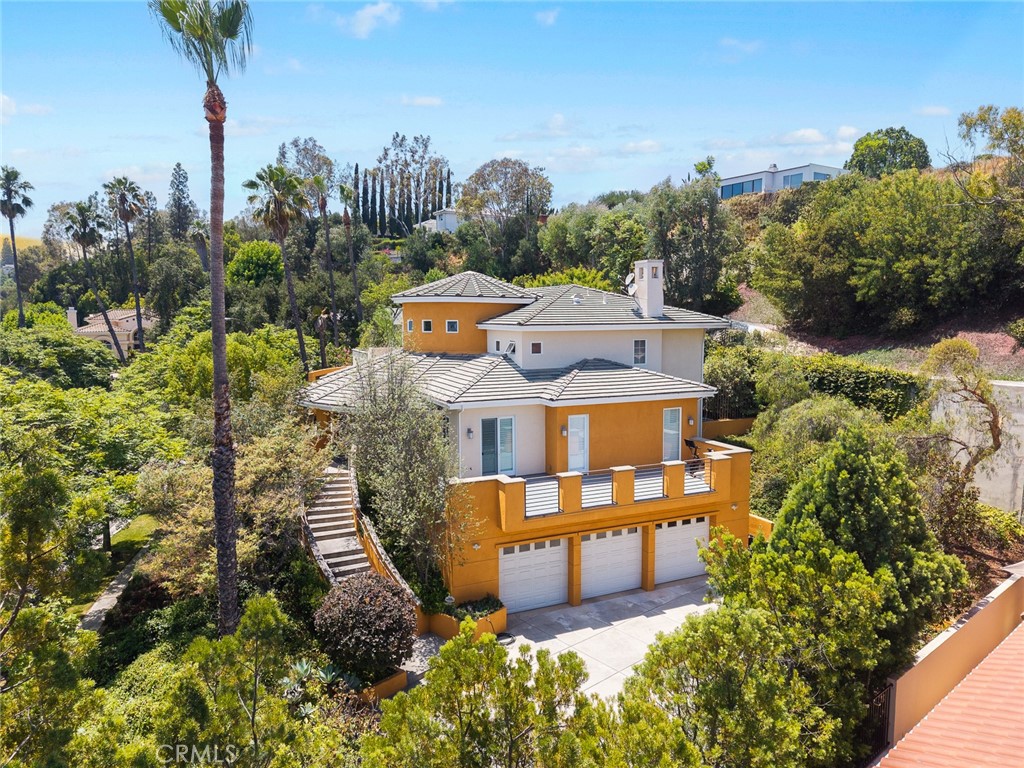 Idyllically located in Braewood Court, one of South Pasadena’s only gated communities, this 4,512 square foot custom estate spares no expense in luxury appointments and modern amenities. Perfectly perched above street level, the home offers maximum privacy along with breathtaking views of the San Gabriel Mountains and twinkling city lights.A dramatic two-story entryway sets the tone for the home’s incredibly open and modern layout—truly an entertainer’s dream. The expansive floor plan includes formal living and dining rooms, a gourmet chef’s kitchen with granite countertops, a center island, high-end appliances, and custom cabinetry, as well as a family room with fireplace and wet bar that opens through French doors to the outdoor living spaces.The home features 4 spacious bedrooms (including 3 en-suites and a grand master suite), 4.5 bathrooms, a dedicated study, multiple balconies, and a 3-car garage. Elegant interior details include marble and Santos mahogany floors, recessed ceilings, a custom granite medallion, a striking 52" crystal chandelier, detailed wood molding, and thoughtfully designed built-ins throughout.The beautifully landscaped front yard with lush greenery creates a serene and inviting ambiance from the moment you arrive. The backyard is masterfully designed with feng shui principles, featuring a tranquil water fountain, a deck floating above a peaceful pond, and generous patio space for outdoor dining and relaxation—ideal for both quiet reflection and entertaining guests.All of this is located within the award-winning South Pasadena School District, offering both prestige and access to top-tier education. This one-of-a-kind estate seamlessly blends architectural sophistication, natural beauty, and modern luxury in one of the most coveted locations in the area.
.