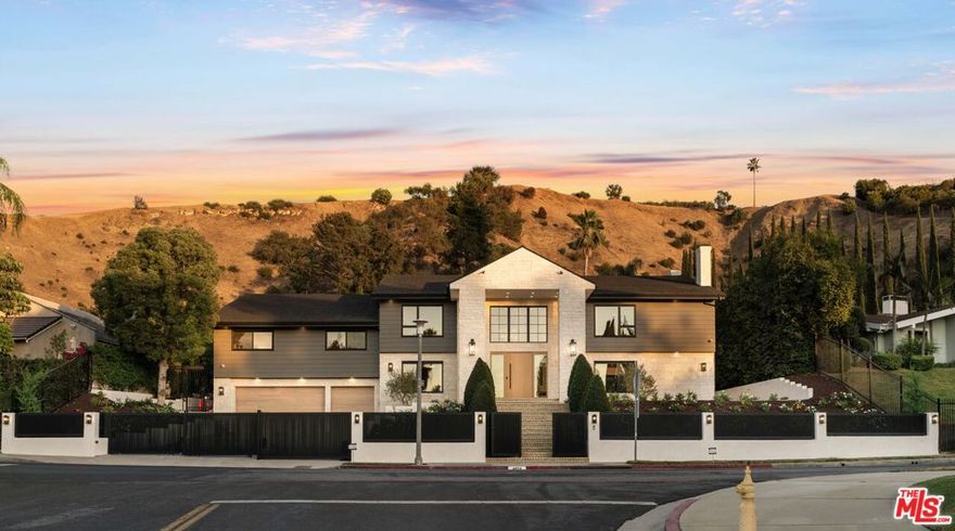 Introducing 4072 Alonzo Ave, a stunning re-envisioned residence nestled in the scenic hills of Encino. This modern architectural gem seamlessly blends sleek contemporary design with warm stone accents, offering exceptional curb appeal and timeless sophistication. The spacious two-story layout features expansive windows, clean lines, and a grand entry framed by lush landscaping and a striking gated facade. Thoughtfully transformed with high-end finishes and seamless indoor-outdoor flow, this home provides a refined living experience in a prestigious, private setting just minutes from Ventura Boulevard's premier dining, shopping, and entertainment.
