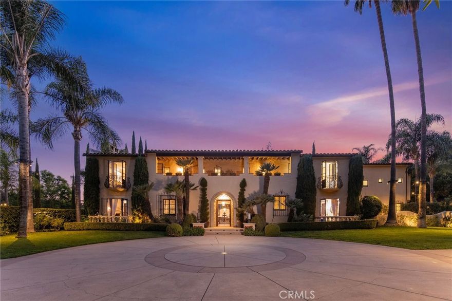 A rare courtyard estate in Pasadena’s prestigious Lombardy Road enclave, this 1931 Wallace Neff Mediterranean masterpiece blends timeless design with modern luxury across gated resort-style grounds. A sweeping tree-lined drive leads to a manicured façade framed by gardens and mature landscaping. Enter through the arched stone portico and wrought-iron front door into a grand foyer with century-old terracotta original Spanish tile flooring. The formal living room showcases a signature Neff fireplace, vaulted beamed ceilings, and arched windows and French doors overlooking the pool, gardens, and an outdoor living room embraced by vibrant bougainvilleas. The formal dining room opens to a terrace with mountain views and flows seamlessly into the entertainer’s kitchen. The chef’s kitchen features an oversized island, professional-grade appliances, and a separate wok kitchen—designed for everything from casual meals to grand-scale entertaining. Upstairs, the grand primary suite, which offers balconies with mountain and garden views, a fireplace, dual walk-in closets, and a spa-style bath with soaking tub and rainfall shower. An adjoining retreat functions as a gym, office, or bedroom. Three additional ensuite bedrooms complete the upper level, with a main-level ensuite for guests. The exquisitely crafted lower level is dedicated to leisure, offering a private theater, game room, billiards lounge, and a climate-controlled wine cellar. Outdoor living is unrivaled, with a full kitchen and bar pavilion connecting to the pool, spa, firepit lounge, and expansive lawn. Terraces, balconies, floor-to ceiling French doors and oversized windows throughout the property invite natural light and garden views at every turn.  Modern features include premium indoor/outdoor surround sound, water filtration, Cat-5 wiring, and smart-home infrastructure. A separate guest house provides flexible space for extended stays, a home office, or multigenerational living. 3477 Lombardy Road is more than a home—it’s a extraordinary architectural offering where legacy design and California lifestyle converge.