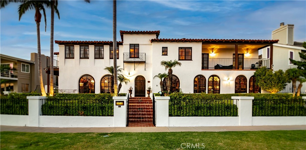 A rare jewel of the California coast, Casa Hermosa is more than a home—it’s a once-in-a-lifetime chance to steward an irreplaceable piece of Doheny history. Built in 1929 and masterfully restored, this Spanish Colonial Revival masterpiece sits proudly on a coveted double lot in one of Dana Point’s most premier beach-close locations. As a registered historic landmark with Mills Act tax benefits, no HOA, and no Mello-Roos, it offers a blend of exclusivity, charm, and financial advantage rarely found along the shoreline.
Behind its private gates, you’ll discover a world where architectural artistry meets modern sophistication. The white stucco façade, red clay tile roof, arched corridors, and hand-carved woodwork speak to nearly a century of heritage. Inside, gracious living spaces include two primary en suites (one upstairs, one main level), a grand family room, elegant library with poker room, chef’s kitchen with professional appliances, and original staircase leading to three additional bedrooms. Sun-drenched morning rooms, Palladian windows, and terracotta floors create an atmosphere of timeless romance.
The grounds are just as captivating: a hand-stained terracotta motor court, two private courtyards for intimate gatherings, a detached pool house with vintage speakeasy-style lounge, exterior wine cellar, and two-car garage. Potential ADU/JADU opportunities await city approval.
Whether envisioned as a private coastal retreat, a showpiece primary residence, or an heirloom to pass through generations, Casa Hermosa stands as a rare bridge between California’s storied past and its most luxurious present.