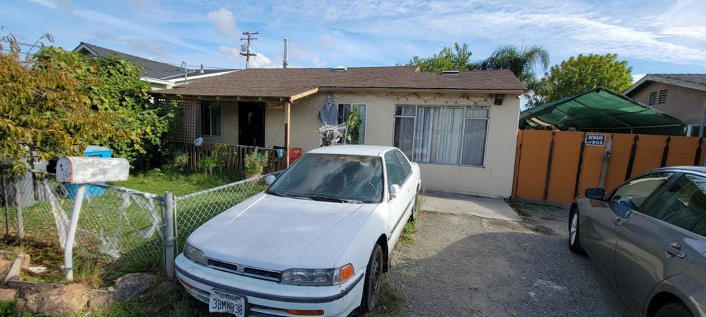 Affordable home. New laminate floors in all 3 bedrooms & living room. Bathroom linoleum floors less than 2 years old. Water heater & stove approximately 1 year old. New energy efficient windows. Garage converted to 3 bedroom by previous owner (permits unknown). Deep lot with storage shed. Indoor laundry room. Sold "As Is". Lots of parking in front and side yard. Seller can carry a first loan. Please do not disturb tenants.