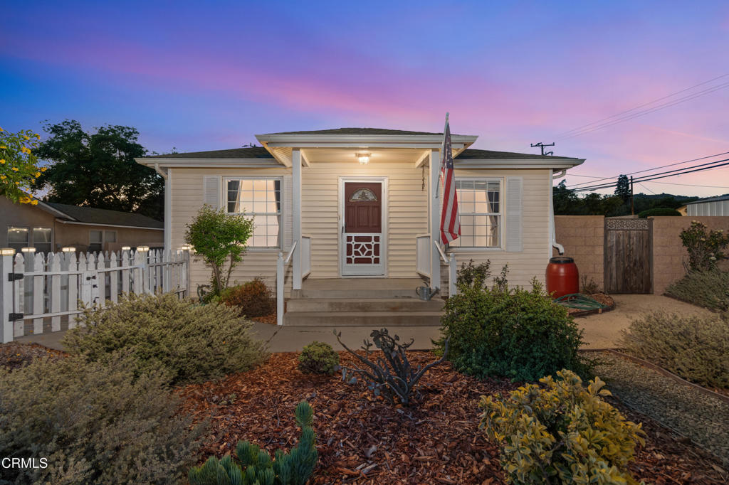 Live at The Camarillo Heights Cottage! This quaint, 3 bedroom & 2 bathroom home sits on a large 9,352sf lot with plenty of parking space for your vehicles, RV, boat, trailer, & more! The tastefully landscaped front yard features a variety of plants for pops of color and is perfectly packaged by a classic white picket fence. As you enter the home, you're welcomed into the living room by beams of natural light that dance off the golden oak pergo flooring. At your right are french doors that lead into the home's 1st guest bedroom that has a vantage point of both the side yard garden and front yard landscaping. Moving into the heart of the home is the dining room which seamlessly flows into the kitchen for easy meal time prep & conversation. The kitchen's ample counter space, large sink basin, floating shelves, and pull-out pantry drawers make it incredibly functional. Just off the kitchen is the laundry/utility room and the guest bathroom. Heading back to the center of the home and into the hallway is the 2nd guest bedroom to the right and the primary bedroom to the left. Both bedrooms have good closet space and views of the side yard garden. The primary bathroom is big, featuring a dual vanity, 3 panel medicine cabinet, and a floor-to-ceiling storage cabinet unit. Circling around to the backyard space, you'll exit the back door onto a wood deck that spans almost the width of the home. This space opens up to a firepit area, a lush lawn, several fruit trees, a covered patio, and a chicken coop at the very back. The side yard garden is ready for you to indulge your green thumb with 2 raised beds (equipped with a drip system) and a storage shed. The other side of the home is a continuation of the massive driveway... there's also a 'secret garden' at the far back corner behind the garage. In the garage, you have plenty of space for 2 cars and you also have a creative/workshop/office space to utilize for projects. Rounding out the property's offerings are a newer Central AC/Heat System, ceiling fans in most rooms, quartz counters in bathrooms, bistro lights surrounding the backyard, automatic drip irrigation for the landscaping, double pane windows, attic storage in garage, solar fence post lights, and an overall charming vibe for a place to live! Don't miss your chance to call The Camarillo Heights Cottage your home!! ....Fun Fact: The home was previously a faculty/farm house at The Camarillo State Hospital (now CSUCI) and was relocated to the heights in the 70s