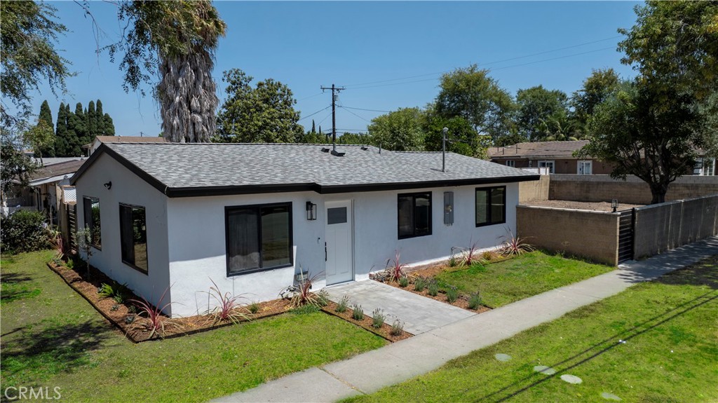Discover this turnkey Santa Ana gem within blocks from historic Main Street in old town Santa Ana, with close access to the 55 and 405, John Wayne and South Coast Plaza — a fully remodeled home with permits offering high-end finishes, modern systems, and an expansive private lot. Situated on a huge corner lot in the heart of Orange County, this property is perfect for first-time buyers or investors looking to expand with large back yard with room to build ADU or home addition.
Everything is NEW and has been thoughtfully done: brand-new roof, new waterproof thick luxury vinyl wood floors, and vaulted ceilings with R-30 insulation. Enjoy new drywall and paint, new exterior stucco, all-new windows and doors (including a privacy WiFi-controlled exterior door), and walk-in closets. The chef’s kitchen boasts premium wood cabinets with soft-close doors and drawers, quartz countertops with matching backsplash, and stunning white-and-gold appliances — refrigerator, range, hood, dishwasher, and washer/dryer tower.
Major systems are fully modernized with a WiFi-controlled ductless mini-split (3 zones), new tankless water heater, new plumbing re-pipe throughout, new 200-amp electrical panel, new wiring, outlets, switches, and ceiling lights, plus an EV charger outlet in the yard. Tech features include wired Ethernet for exterior POE security cameras, a WiFi doorbell, and AT&T fiber internet availability.
Outside, enjoy mature trees, a new concrete patio, front porch pavers, and complete privacy with brick walls and new steel gates. There’s secure inside-gate parking for a boat, RV, or business equipment. The spacious lot is ADU-ready and offers room to expand the home for additional income potential.
With all work completed with permits, this property is a rare blend of style, function, and investment opportunity. Buyers can possibly qualify for $10k down payment assistance program with Wells Fargo for the mortgage, call for more information.