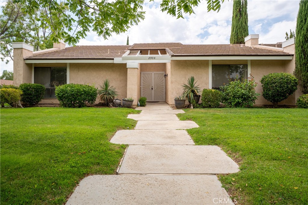 Welcome to College Terrace! This spacious 3-bedroom, 2-bath condo offers 1,802 sq. ft. of comfortable living on a beautiful tree-lined street near Antelope Valley College. Step inside to find a remodeled kitchen, new heating & air conditioner (2 yrs.) a large living room with a cozy fireplace, and generously sized bedrooms. The versatile enclosed patio is perfect for a sewing room, home office, or creative space. Enjoy the convenience of an attached 2-car garage and the charm of this well-maintained community. A rare find combining size, location, and value at $434,000!