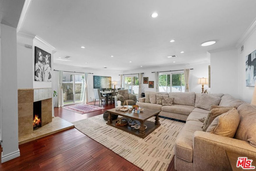 Located in a highly sought after Tarzana neighborhood, this bright and open single story home offers 3 bedrooms, 2 bathrooms, and a sparkling pool. The upgraded kitchen features granite countertops, new stainless steel appliances, a garden window, spacious cabinetry, and ample counter space. The living room showcases gleaming wood floors, high ceilings, recessed lighting, and a cozy fireplace, with sliding doors that create a smooth indoor-outdoor flow to the pool and side yard. Both bathrooms are beautifully designed with modern vanities and updated showers. Wood floors continue throughout the bedrooms and hallways, enhancing the home's warm and elegant feel. Set on a large, flat lot, the property boasts impressive curb appeal with a wraparound yard that provides plenty of private outdoor space. Perfect for entertaining, the backyard includes a built-in BBQ, fire pit, and large pool, an ideal retreat for gatherings with family and friends.