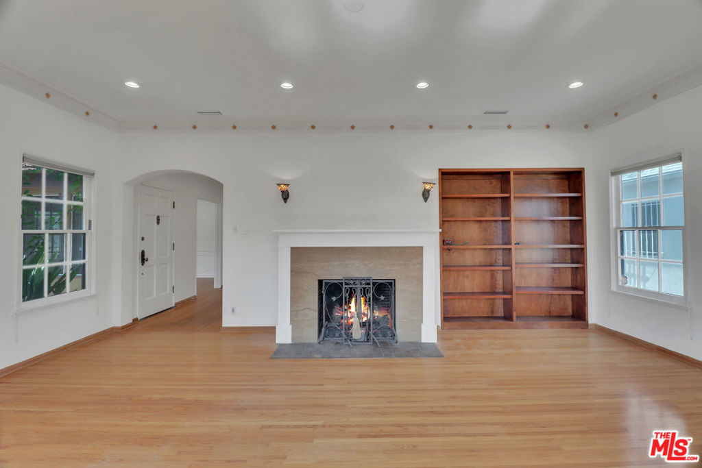 Located in the desirable Carthay neighborhood of Los Angeles, this charming home blends historic character with modern comfort. Set on a peaceful, tree-lined street near Beverly Hills, Miracle Mile, and major job centers, it's ideal for tenants seeking a quiet residential vibe with easy access to dining, shopping, and transit. Inside, the home features warm hardwood floors, crown molding, recessed lighting, and a spacious layout. The formal dining room is filled with natural light and opens gracefully into the formal dining room perfect for hosting or enjoying meals with family. The kitchen offers ample cabinet space and leads to a separate laundry room with stacked washer/dryer and outdoor access. Large bedrooms with ample closet space. The private backyard is an inviting retreat, complete with a tiled patio for outdoor dining, artificial turf lawn for low-maintenance greenery, and mature trees offering privacy and shade. A detached studio with kitchenette and full bath adds flexibility for guests, office, or creative space. With stylish bathrooms, updated fixtures, and thoughtful details throughout, this home is a standout rental in one of LA's most convenient and charming neighborhoods.