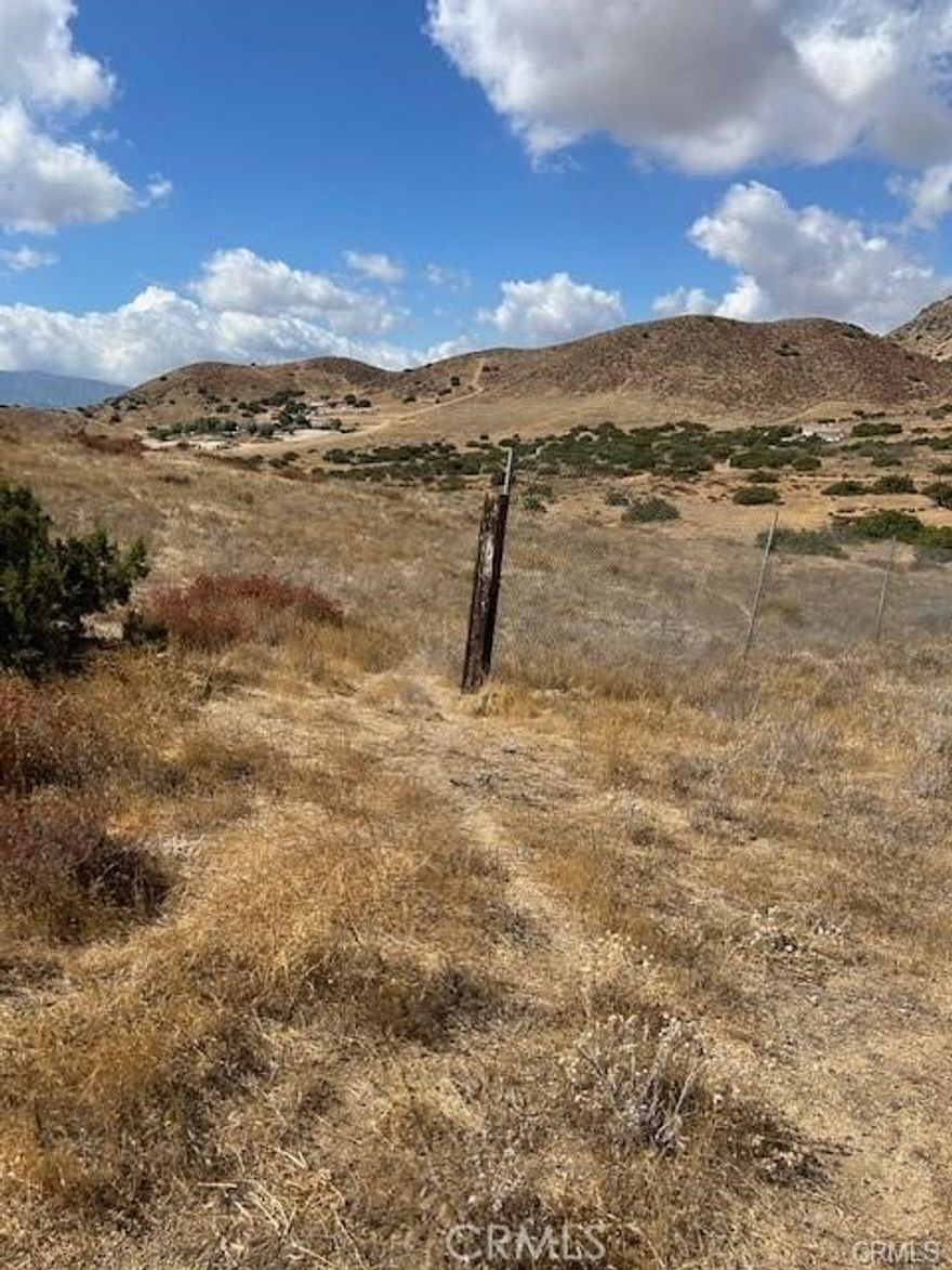 This prime parcel of land is tucked away in a breathtaking valley, offering a unique opportunity to build your dream home or weekend retreat. The property sits atop a small hill, providing breathtaking panoramic views of the surrounding valley and scattered neighborhood. With an abundance of natural privacy, this lot is ideal for those seeking tranquility and space to spread out.



Surrounded by open space and minimal neighbors, this is the perfect spot for those who value peace and seclusion without sacrificing convenience. The land offers plenty of potential for development, with electricity nearby and most properties in the area relying on water wells, so buyers should confirm the availability of both power and water.



Whether you're looking to create a private oasis or simply enjoy the beauty of the Acton landscape, this property offers a rare combination of privacy, views, and potential. Don't miss out on this opportunity to own a slice of scenic California land!



Buyer and Buyer’s Agent to verify availability of water and power.