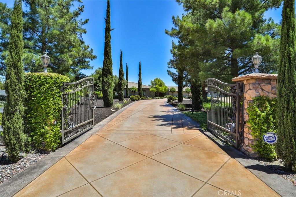 Sprawling Single Story Gated Estate in the Heart of Temecula Wine Country with Resort Style Backyard. Over 6,000 Sq Ft Residence on Five Acres.  Incredible Location @ Rancho California Road Wine Trail, Walking Distance to Several Award Winning Wineries. Car Enthusiasts Bring Your Treasures! Nine Car Garage Awaits! Soundproof Room for Musical Enthusiasts and Gorgeous Wine Cellar Awaits Your Friends and Wine Enthusiasts. Multiple Patios, Large BBQ Island, Outdoor Fireplace and Two Firepits. Huge Impeccably Maintained Lawn Ready for All The Lawn Games and Entertainment. Spectacular Salt Water Pebble Tec Swimming Pool Includes Large Waterslide, Bar, Reef Entry, Waterfalls and Oversized Spa. This Remarkable Residence Includes Oversized Primary Suite with Retreat, Luxurious Bathroom, Spacious Walk-In Closet with Organizers and Dual Fireplace. This Home Offers Four Fireplaces. Huge Den/Bonus Room is Currently Used as a Sixth Bedroom, and it's Adjacent to Wonderful Home Theater. Enormous Chef's Kitchen Includes Massive Center Island. Watch the Wine Country Hot Air Balloons Soar from Your Backyard. Approximately 1.5 Acres Are Beautifully and Fully Landscaped and 3.5 Acres are Currently All Natural, Ready for Your Vineyard, Orchard, Equestrian Facilities or an Ultimate Playground?!No HOA, low property tax rate and paid solar with 72 solar panels are included!