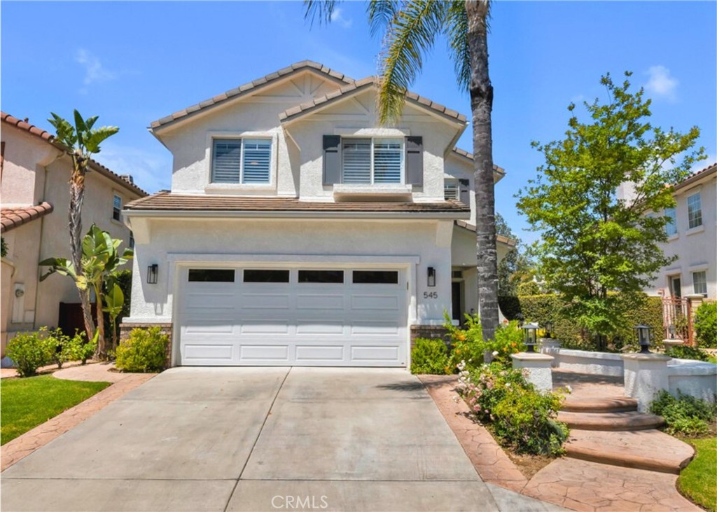 Welcome to 545 Shadow Lane, Simi Valley Tucked away in the coveted gated Wood Ranch community, this beautifully updated 4-bedroom, 2.5-bathroom home offers the perfect blend of comfort and functionality. From the moment you arrive, you'll appreciate the pride of ownership and thoughtful upgrades throughout. Step inside to discover a light-filled interior featuring an open-concept layout, white oak flooring, and high ceilings that create an airy, inviting atmosphere. The main level offers both formal living room, dining room, and a cozy family room with a fireplace. Upstairs, the spacious primary suite is a serene retreat with a walk-in closet and a spa like en-suite bath featuring dual vanities, a soaking tub, and a separate shower. Three additional upstairs bedrooms share a well appointed updated full bathroom. Outside, enjoy the private backyard with outdoor fireplace, putting green, low maintenance landscaping, and a patio perfect for outdoor dining or relaxation. Located minutes from parks, hiking trails, and the Wood Ranch Golf Club, this home is a rare find in one of Simi Valley's most desirable neighborhoods.