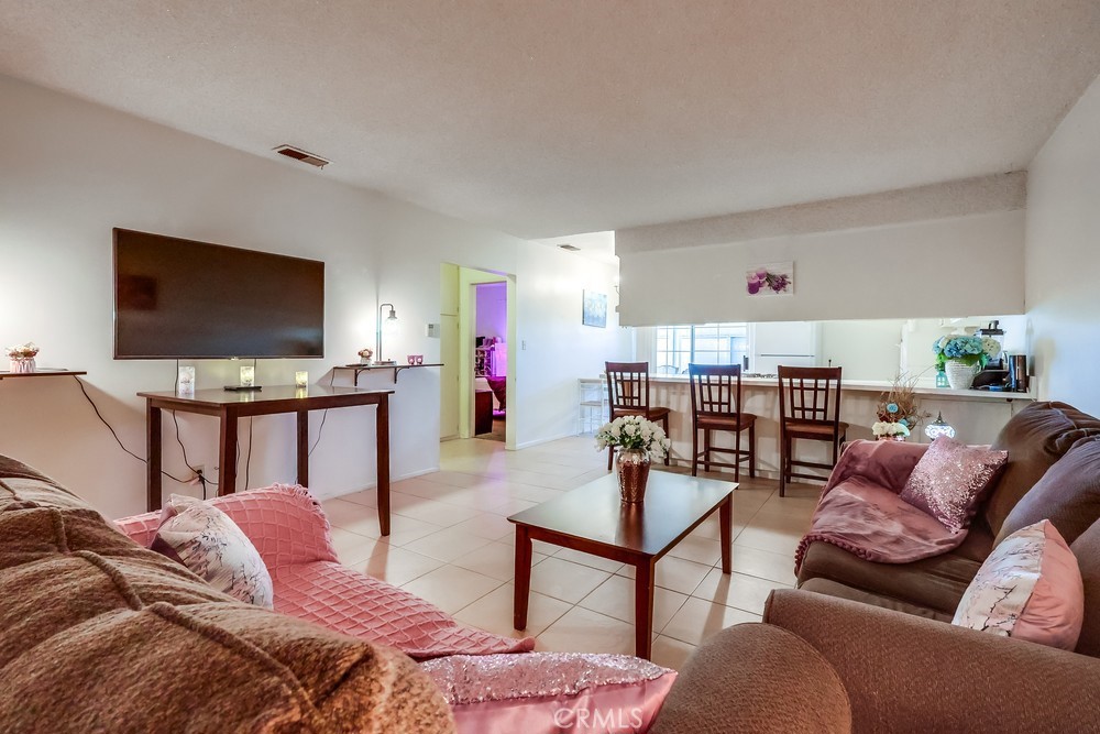 Beautiful 2 Bed, 2 Bath(1 level)condo on ground level, NO STAIRS! Enter front door to nice tile floor, living room next to open kitchen with white cabinets, GAS wall oven, GAS cooktop stove, exhaust hood, fridge, & vinyl slider that opens to lovely enclosed, private rear patio(ground level) with side lawn & gate that opens to your PARKING SPACE(R2/48) directly behind unit. 2 big bedrooms included: 1 on right has room for big bed w large closets & ur own 3/4 bathroom. Down short hall is 2nd bedrm with wood floors, big closets, next to FULL bathroom w/ shower, tub, toilet, & vanity. Come back thru kitchen, open slider to your own private, ENCLOSED patio with washer/dryer on the right & huge area for sitting/BBQing to the left w grassy play area for pets/kids. Private gate in patio, opens to your covered parking spot #48 in rear. Complex is NOT gated, but There are 2 separate GATED entrances for parking (U get 2 clickers). HUGE community pool in center of complex, gated for safety w small clubhouse/changing room in pool area. Click on Supplements 2 see MAP 2 navigate from Street Entrance to rear row of the complex. Stay to right of pool & walk to rear row on rt hand side, your unit is #R2 or #39 on door. LOW HOA: only $270. ****Ask about F H A, yes ....Plenty of street parking. Hospital 1 block away & close to all shops, restaurants & 91 Freeway.