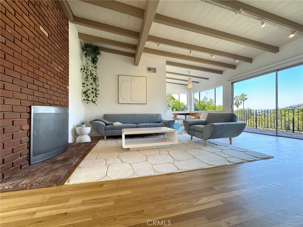 Welcome to 2307 El Contento Dr — and 2302 Alcyona Dr.
A rare find in the Hollywood Hills, this unique property spans two different streets, offering two separate addresses—each with its own entrance—on a single lot. With access from both El Contento Drive and Alcyona Drive, the home unlocks incredible potential for future development, rental income, or truly flexible living.
Tucked away in the coveted Hollywood Hills, this private 1,955 sqft hillside retreat blends sunset facing sweeping views with serene surroundings, stylish interiors, and everyday convenience.
Inside, the updated 3-bedroom, 3-bathroom home features a light-filled, airy layout with a spacious living room, family room, two fireplaces, and two oversized balconies—perfect for enjoying panoramic canyon and city views, from morning coffee to golden-hour sunsets.
The kitchen flows easily into the main living areas and includes its own private entrance. Multiple sliding glass doors invite seamless indoor-outdoor living. A detached 240 sq ft guest unit with its own ¾ bath offers ideal space for visitors, a home office, or a creative studio.
The Alcyona Drive address sits on a cul-de-sac and is perfectly suited for private access to a future addition or ADU—ideal for expanding your vision.
Additional highlights include:
• Mid-century charm with modern updates
• Private patio and outdoor lounge areas
• Recently updated interiors
• Spacious laundry room
• Covered 2-car carport
• Lush garden with mature fruit trees
Just minutes from Hollywood, Los Feliz, Silver Lake, West Hollywood, Larchmont Village, the 101 Freeway, and the scenic Hollywood Reservoir, this unique hillside gem offers privacy, versatility, and inspiring views—right in the heart of one of L.A.’s most sought-after neighborhoods.