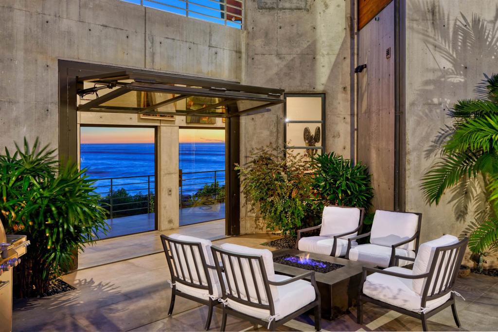 PRICING IMPROVEMENT! Experience La Jolla ocean front living at its finest from this prime property located on perhaps the most coveted street in La Jolla. Modernist in style, blending raw concrete, teak wood, metal and glass converging with carefully curated architectural artifacts, create this one-of-a-kind residence. Offering an intimate relationship with the ocean, the positioning on the bluff could never be duplicated. Expansive south coast views (with night lights) and beyond along with year-round sunsets and accessible sandy coves below, deliver both a sublime living experience and a seamless connection to the natural marine environment. Room configuration includes separate entry to guest quarters, a library/den, a bonus room currently used as a gym and an additional detached gym option. Garage setup offers a custom lift system to accommodate 4 cars.