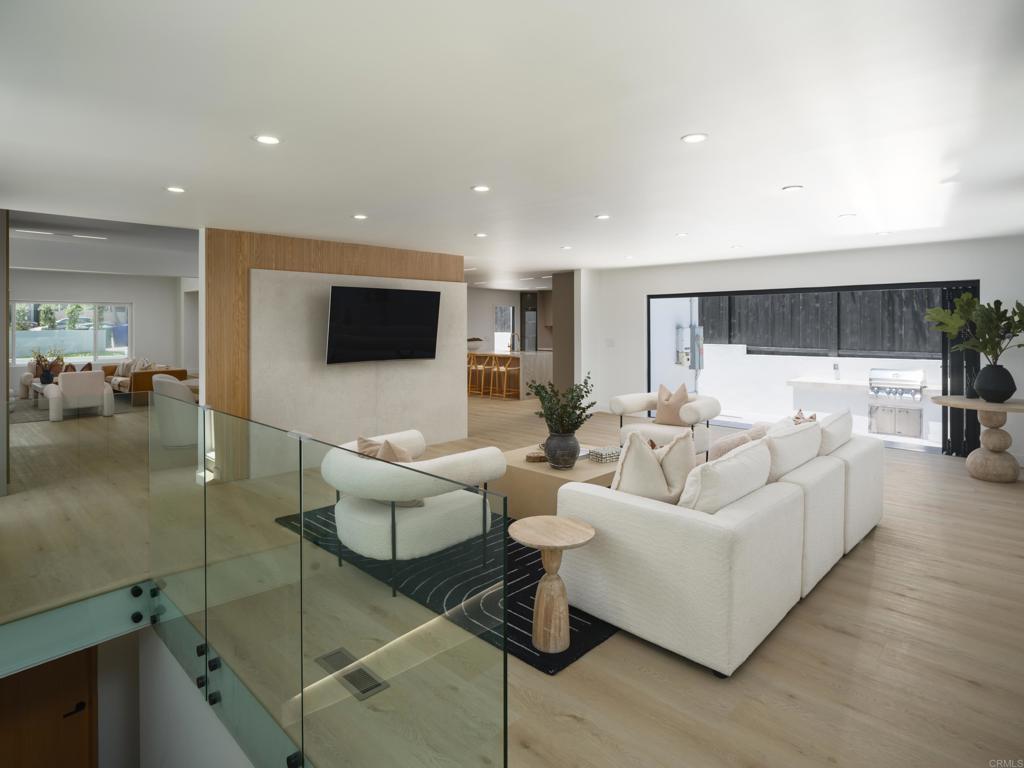 Welcome to your dream home in one of San Diego’s most coveted neighborhoods. This fully reimagined 4-bedroom, 3.5-bath residence offers over 3,200 sq ft of designer-curated living, with $400,000+ in premium upgrades throughout. From its striking curb appeal to the sleek white oak pivot door, every detail has been crafted to impress. Inside, enjoy luxury vinyl plank flooring, Taj Mahal quartzite counters, custom Euro-style cabinetry, and dramatic floor-to-ceiling tile accents. The open-concept layout is perfect for both everyday living and entertaining, highlighted by a chef’s kitchen and a 16-foot bifold door that connects seamlessly to the outdoor oasis complete with built-in BBQ, serene landscaping, and space to relax or gather. The spa-inspired primary suite offers a true escape with a soaking tub, double vanities, and elegant gold finishes. Unique features like a sculptural staircase, glass wine cellar, and full smart home integration bring sophistication and innovation to everyday life. With top-tier dining, shopping, and beaches just minutes away, this home blends high design with laid-back California living. Don’t miss this rare opportunity, schedule your private tour today.