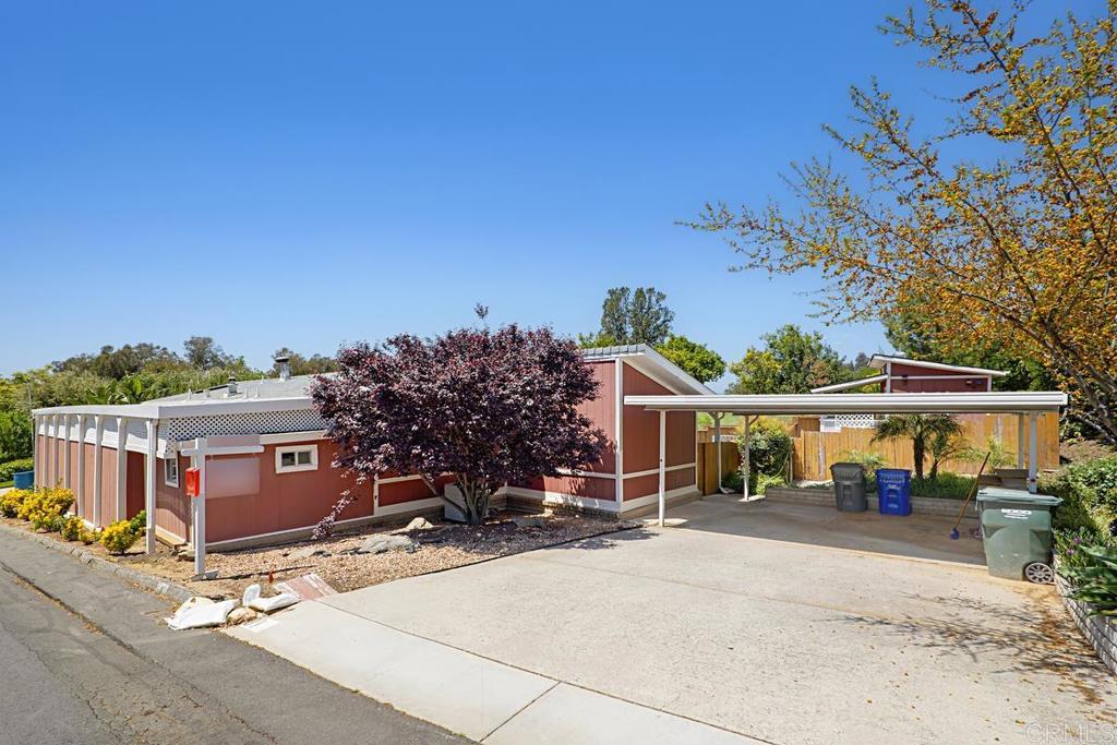 LIVE RIGHT ON THE GOLF COURSE!! Please come and see this lovely 2 bed/2 bath 1976 manufactured home that has 1344 esf and is listed for only $169,000!!! Located in Skyline Ranch Country Club, a premier Senior Park that is located in the foothills of Valley Center. It includes a lovely back yard with mature fruit trees including an orange, lemon, lime, grapefruit, and a tangelo. There is a beautiful rose garden, an area to garden, and a nice storage unit. The home has a screened porch perfect for dining or perhaps an exercise room. A pellet stove warms the living room plus adds nice ambience. The covered carport offers side by side parking. This home is located in Skyline Ranch Country Club, a premier Senior Park that sits in Valley Center. Currently offering free golf to all residents, full clubhouse use, dog park, gym, senior community, and much more. Skyline Ranch is a land leased park where the monthly space rent here is 1600.00. Please come and see this amazing home.