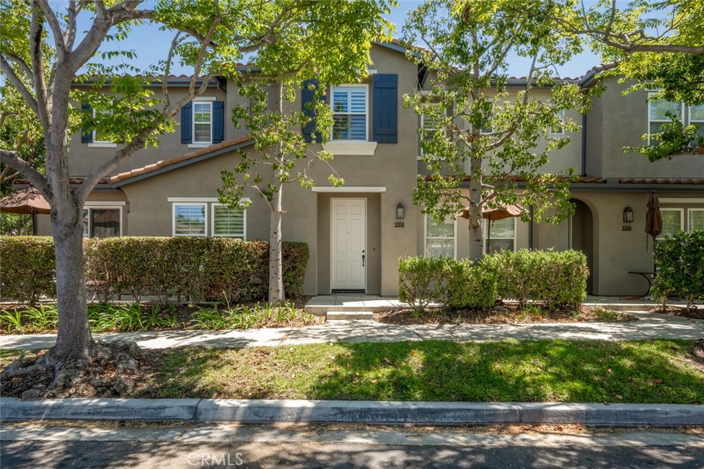 Welcome to Laurels at Providence Ranch, a gated community in the coveted South Coast Metro Region. This conveniently located 3-bedroom/ 2.5-bathroom townhome with attached 2-car garage was built in 2004 and offers a turnkey living experience with a host of desirable features. As you enter after walking past the patio seating area, you'll be greeted by the light and bright open floor plan, complemented by natural-look tile flooring and 9' ceilings, making for a spacious and inviting atmosphere. The combined living and dining areas flow into one another and are adorned with a gas fireplace and space for an entertainment center, perfect for cozy evenings and friendly gatherings. The home also features an aptly designed kitchen, showcasing timeless granite countertops, crisp white cabinetry, stainless steel appliances and a sink that looks into the open living/dining area for ease of finishing up in the kitchen while entertaining. Upstairs, an en suite primary bedroom retreat features a spacious walk-in shower and sizable walk-in closet. Two nicely sized secondary bedrooms and a full second guest bathroom round out the sleeping quarters. For added convenience, there is a separate laundry room with storage cabinets and space for a washer and dryer. Positioned only steps away from the community pool, spa, and BBQ area, the home provides easy access to amenities without sacrificing privacy. HOA amenities also include a playground for the littles, ensuring ample recreational opportunities just steps away. The location of this property is unbeatable, with quick access to the 405 Freeway, John Wayne Airport, South Coast Plaza, renowned dining options, theaters, and the Segerstrom Center for the Arts. Enjoy a day of shopping at South Coast Plaza, catch a show at the theater, or immerse yourself in the vibrant arts scene. With a short, 15 minute commute to the beach, you can easily indulge in the coastal lifestyle. Impressive and available for immediate move-in– don't miss your opportunity to be part of this world-class community, offering convenience, luxury, and a vibrant lifestyle.