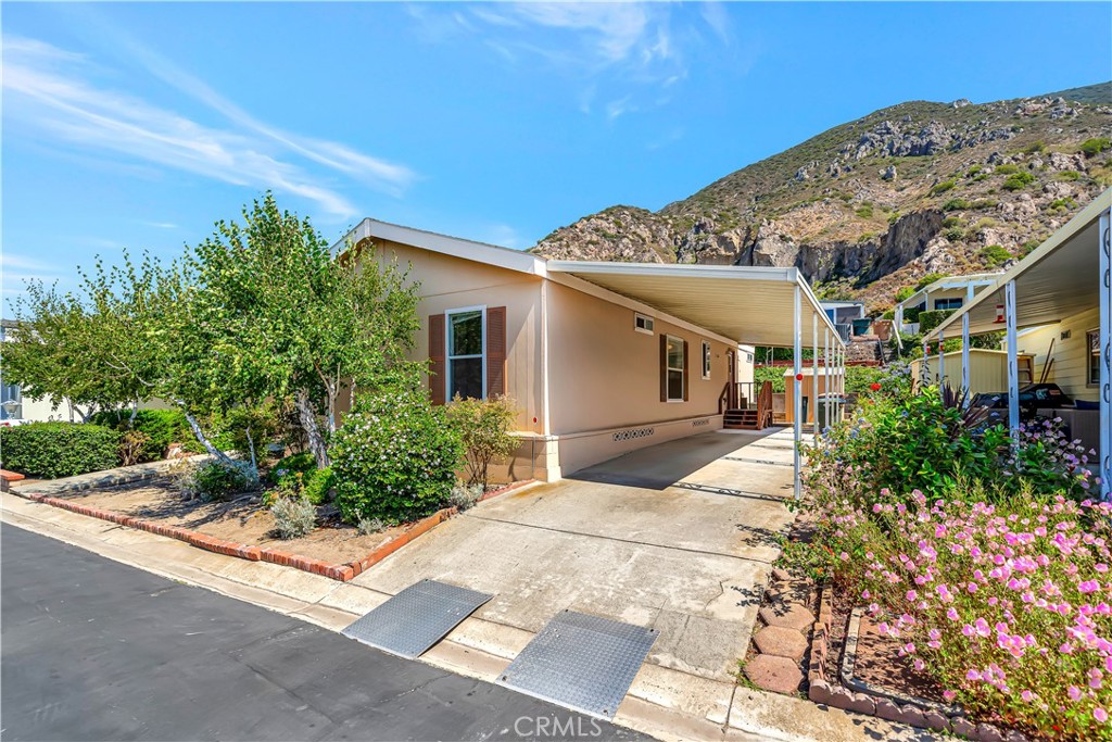 Rarely on Market! This is the first newer Manufactured Home to come on the market in recent years in Camarillo Springs where the you own the land! Built in 2005 this lovely manufactured home in a 55+ senior community (for couples, only one individual must be 55+ not both) has an open floor plan with 3 bedrooms and 2 baths and indoor laundry and lush landscaping along with drip water system and fruit trees. Located in the lovely gated senior community of Camarillo Springs, this home is wonderfully situated with beautiful mountain views and is near a golf course. Property includes additional storage shed and is A/C ready, but who needs it with the temperate Camarillo climate and ocean breeze? Additionally, there is a community pool and clubhouse! + Free Parking for RV and Boat!!