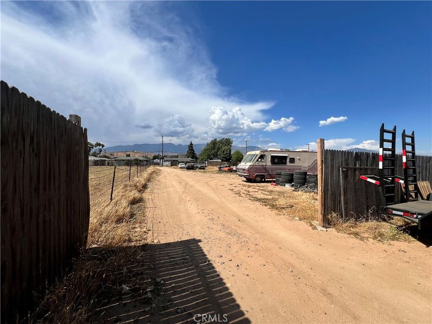 Over 30,000 Sq Ft Flat Lot in the City of Banning - Horse Property with Mountain Views. This spacious and usable lot features over 30,000 square feet of flat terrain, ideal for building a custom residential home. Located in the City of Banning, the property currently features horse corrals, newer wood fence, 900 Square feet of covered outdoor living with an expansive 30x30 patio cover. Enjoy beautiful mountain views and peaceful rural surroundings, with access provided through a city easement. A rare opportunity to own land with open skies, utility potential, and room to grow. Owner might Carry back the loan with the right downpayment.
