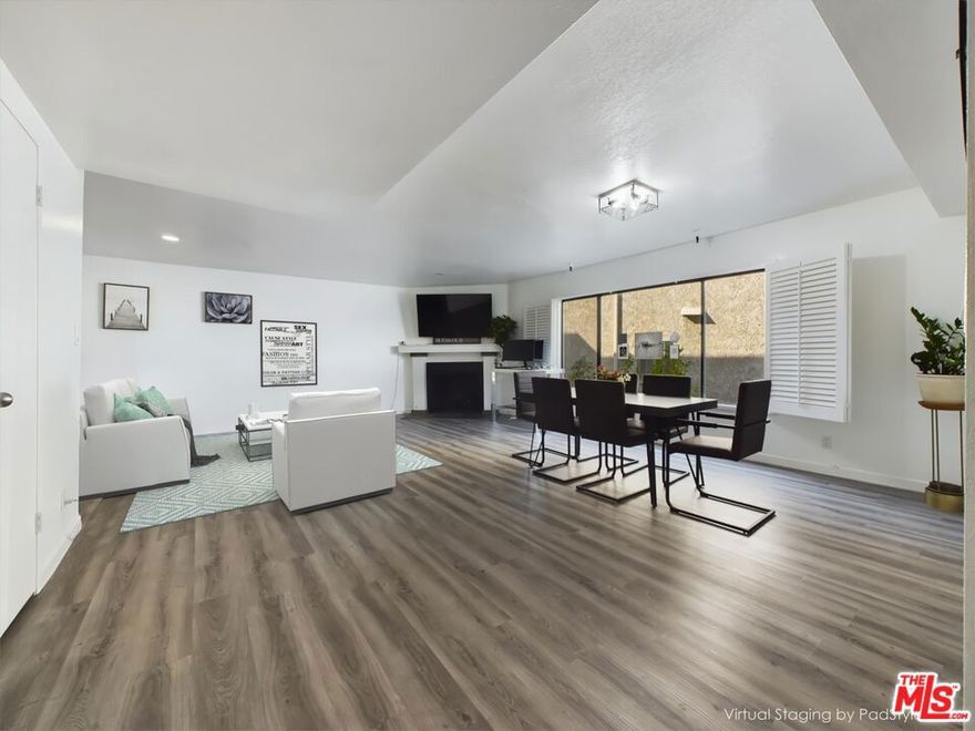 Nestled in the heart of prime Sherman Oaks, this exquisite 2-story townhouse is located within an exclusive 5-unit complex. Designed with modern elegance, the residence features 2 spacious bedrooms and 2.5 beautifully updated bathrooms. The expansive open living and dining area is bathed in natural light streaming through grand windows, accentuating the upgraded flooring and a sophisticated fireplace. The gourmet kitchen, along with the tastefully remodeled bedrooms and bathrooms, offers the perfect blend of luxury and functionality. Indulge in the convenience of in-unit side-by-side laundry and a generous walk-in closet. The property includes a private 3-car garage with side-by-side parking. The HOA provides peace of mind, covering earthquake insurance, roof maintenance, water, trash, and a meticulously maintained common yard. Located just steps from Ventura Blvd, this home offers unparalleled access to upscale dining, entertainment, and shopping, including Pavilions. With proximity to the 101 and 405 freeways, this residence combines luxury living with exceptional convenience. Washer and dryer are included, making this modern townhouse ready for you to move in and enjoy.