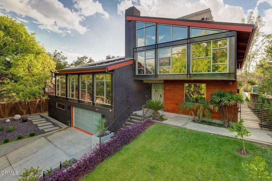 Discover the pinnacle of refined architectural design, where modern living seamlessly integrates with the natural world. This residence has been intentionally crafted to dissolve the line between indoor comfort and outdoor splendor, featuring soaring 15-foot ceilings and expansive folding glass walls that flood the space with light and open directly to the surrounding landscape. Towering walls and open-plan interiors radiate with daylight, creating a serene and elegant atmosphere.The sophisticated aesthetic is elevated by a thoughtful blend of materials--European tilework, marble finishes, and bespoke cabinetry--all carefully selected to enhance both form and function. Step outside to the striking infinity-edge pool, where clean, minimalist architecture frames unobstructed vistas of the San Rafael Hills.Every aspect of this home is a testament to refined taste, cutting-edge innovation, and luxury living. The master suite offers spa-inspired features including a steam shower adorned with Porcelanosa tiles and a generously sized air-jet soaking tub. The chef's kitchen is outfitted with premium Wolf, Sub-Zero, and Miele appliances, complemented by a Graff faucet and Blanco sink set in elegant Carrera marble.Notable enhancements include Hunter Douglas window coverings, UV-protective glass, Lynx outdoor kitchen equipment, a robust solar power system with around 58 owned panels, and a heated infinity pool. Designer lighting, integrated stereo speakers, an intercom system, surveillance cameras, and wired data access in each bedroom contribute to a fully connected lifestyle. Additional smart features like dual Nest thermostats and a front entry secured by fingerprint and PIN access round out this exceptional home.
