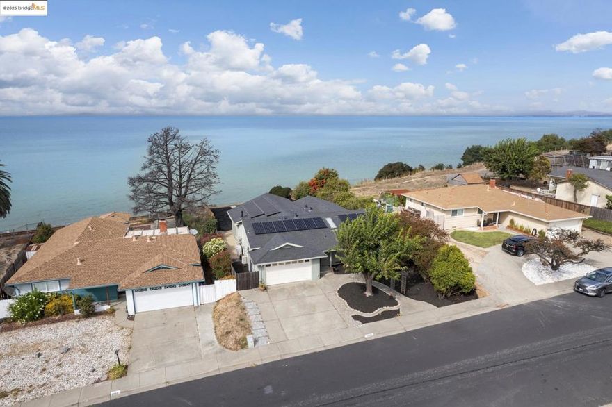 Energy-Efficient Bayfront Retreat With Breathtaking Views! Discover this rare 4BD/2BA home with Unobstructed Views of San Pablo Bay, Point Pinole, and Mt. Tam. This tastefully renovated, single-level home combines comfort, style, and convenience. Soaring ceilings, exposed beams, Regency Gas Fireplace, and a dramatic wall of windows fill the great-room with warmth and natural light, framing the stunning view perfectly. The living room and the primary suite flow seamlessly outside to the spacious flagstone patio perfect for dining al fresco, entertaining, or simply unwinding as boats and seabirds drift by and sunsets paint the sky. The updated kitchen features porcelain counters, custom cabinetry, and newer appliances.The spacious primary suite has an Incredible Bay View, and all 4 bedrooms offer comfort and flexibility. Energy-saving upgrades include solar panels, EV charging station, heat pump with central A/C, newer electric water heater, attic insulation, and some newer windows. It is set on a large lot in a peaceful neighborhood with direct access to parks, trails, and bike paths.And just minutes to dining, shopping, BART, and the Richmond Ferry. Experience the perfect blend of modern efficiency, natural beauty, and bayfront tranquility! Your private waterfront retreat awaits!