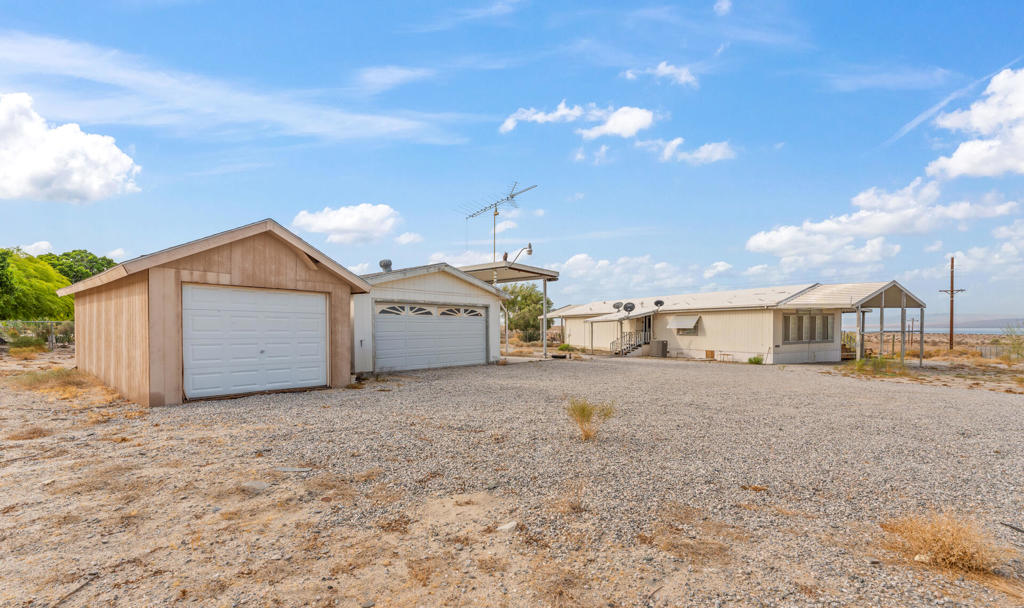 Endless Potential Manufactured Home sitting on a 1.07 Acre Lot!!Looking for a place to make your own?This 2 bedroom/2 bathroom manufactured home offers a rare opportunity to own a full 1.07-acre lot with breathtaking views of the Salton Sea. While the home needs some TLC, the possibilities are endless--fix it up to suit your style, expand, or even start fresh.Property is fenced, has 1 detached garage, a storing shed and an RV porch in place. Spacious, peaceful, and surrounded by natural desert beauty. Imagine relaxing evenings watching the sun set over the water or building your dream retreat just the way you want it. If you're a visionary buyer or an investor looking for a diamond in the rough, this property is calling your name. Don't miss the chance to create something special in this serene and scenic location.Seller will NOT make any repair-manufactured home being sold as is.Manufactured home NOT sitting on permanent foundation and does NOT have certification 433A.Buyer to verify all property information to their satisfaction. Seller and agent make no guarantees or warranties, expressed or implied, regarding the condition, features, or accuracy of property details.