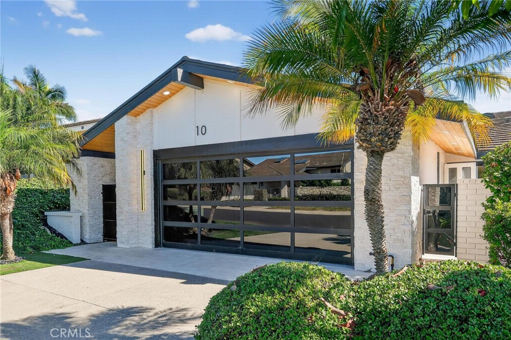 Discover refined coastal living in this beautifully customized Contemporary home located in the exclusive, guard-gated community of Jasmine Creek. Encompassing over 1,900 square feet on a single level, this residence offers privacy, resort-style amenities, and a premier Corona del Mar location just moments from the ocean. Designed for seamless indoor-outdoor living, the home features two spacious bedrooms and two luxurious bathrooms, along with a living room, entertainment room, private dining room, and a gourmet kitchen with breakfast nook. Multiple rooms, including the main suite, open directly to the expansive rear yard and patio, creating the perfect flow for entertaining or relaxing. The chef’s kitchen boasts a Forno 6-burner range, high-end appliances, custom cabinetry, and a pantry with pull-out drawers. The main suite offers a generous walk-in closet and spa-inspired bath with double vanities, a walk-in shower, and a freestanding soaking tub. A secondary suite and charming private patio add to the thoughtful design. Custom stone landscaping, a tranquil waterfall, and walk-up deck enhance the outdoor living experience, while newer appliances, air conditioning, and meticulous finishes complete the home. Move-in ready and crafted for comfort and style, this Jasmine Creek gem presents a rare opportunity to enjoy coastal luxury in one of Corona Del Mar’s most coveted communities.