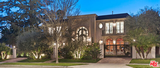 Replete with fine European craftsmanship, this extraordinary 3-level gated Mediterranean estate is the epitome of elegance and luxury. Custom built by its owner and completed in 2008, the home is located on a coveted central Flats' block moments from Beverly Hills' famed "Golden Triangle". Sunlit spaces with super high ceilings, French doors, wood & marble floors, and mouldings. Convenient elevator access to all three floors. Dramatic 2story skylit entry with sweeping stairwell and magnificent iron/glass doors. Gracious living, family, and dining rooms. Separate library/office. 4 bedroom suites up including a huge master with sitting area, big balcony, fireplace, dual baths/walk-ins. 2 suites on the lower level along with a professional screening room, wine cellar, and game room. Stunning and huge center-isle kitchen overlooks grounds with lawns, pool, spa, BBQ center, patios, and mature hedging. 4-car subterranean direct-entry garage in addition to tremendous off-street gated parking.
