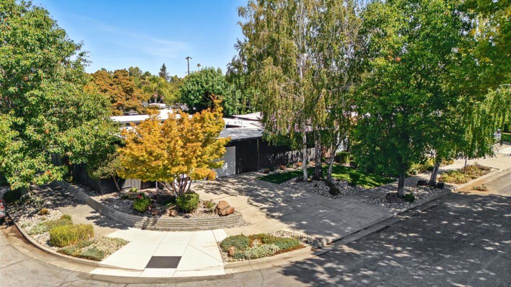 Welcome to 1665 Fairorchard Ave, a beautiful 4-bed, 2-bath Eichler in Willow Glen's sought-after Fairglen neighborhood. Designed by Joseph Eichler, this residence embodies mid-century modern elegance w/its signature open layout, floor-to-ceiling windows & seamless indoor-outdoor flow. Permitted upgrades incl new roof, mini-split AC system, Milgard dual-pane windows & glass sliders,100-amp garage subpanel & modernized kitchen & baths w/Quartz counters. Primary suite features serene yard views w/its' own slider, dual sinks & sep makeup vanity, walk-in closet & new Quartz shower. Throughout the home you will find 10 skylights, radiant floor heating & Terracotta tile flooring. Updated kitchen offers Quartz counters, trough sink, peninsula, & SS appliances.1 bed opens directly to the atrium, making it ideal for home office/guest suite. Crisp architectural lines & custom paint colors highlight the exterior. Signature enclosed atrium serves as a stunning centerpiece, flowing into landscaped front/back yards. Add'l highlights include: new automatic garage door w/remotes, motorized atrium shades, finished garage & backyard space for outdoor dining. Walking distance to Booksin Elementary & mins from The Pruneyard, downtown Campbell, Willow Glen's shops & farmers market. Enjoy!