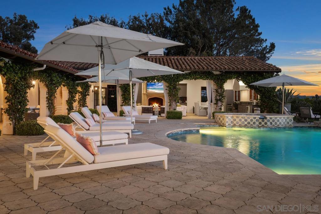 ** Summer and Luxury, year-round ** Renowned interior-design, SELLING FULLY FURNISHED, acclaimed for incredible quality & style. This custom-built Single-Level Estate @16304 Via De Santa Fe, Rancho Santa Fe Covenant is privately gated and sits on 3.31 VIEW acres. Room for tennis, horses or ADU. Amenities. 5+ BR suites residence features Italian limestone & wood flooring, high ceilings, custom steel doors that flood the home w/ natural light, embracing seamless indoor/outdoor living & ideal southwest orientation for Breathtaking Sunsets & Pano VIEWS, Stunning gourmet kitchen outfitted w/ chef-grade appliances, double oven, large prep island, custom cabinetry, and designer finishes at the highest level. Private home office w/ top-tier home automation incl. owned solar, Race Communications fiber internet, and a SONOS-powered surround sound AV system. An expansive 2,900 SF upgraded outdoor living space is an entertainer’s dream—complete with custom cabinetry, stone countertops, and all new appliances: refrigerator, range top, grill, vent, and icemaker. Multiple dining/lounge areas, fire pit, Bocce Ball court, saltwater pool & jetted spa, with newly upgraded irrigation system, organic veggie garden and private well for sustainable, year-round landscaping. The primary suite is a true retreat, offering direct access to a private yard, his-and-her closets, and a spa-inspired bath w/ steam shower, dry sauna, and a deep soaking tub. With quick access to historic Osuna Ranch, local trails, shopping, restaurants, and the Rancho Santa Fe Village.