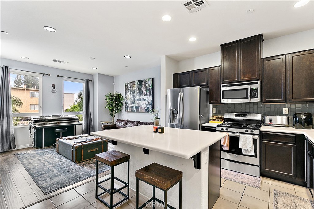 RARE 2.875% ASSUMABLE LOAN – POTENTIAL HUGE MONTHLY SAVINGS! Tucked quietly at the back of the sought-after Azalea gated community, this 3-bedroom, 3-bathroom single family residence is designed to make you feel at home from the moment you step inside. You’ll instantly notice the warm hardwood floors, the glow of recessed lighting, and the natural light that fills every room. Picture yourself cooking in a kitchen equipped with stainless steel appliances, hosting friends in the open-concept living space, or simply unwinding in your spacious primary suite with a walk-in closet and private bath. Need room for guests, a home office, or multigenerational living? You’ve got it! One of the guest bedrooms even comes with its own bathroom and walk-in closet — because everyone deserves their own space. Step outside and discover the kind of amenities that make weekends better — grassy park-like grounds, picnic tables, BBQ areas, and yes, plenty of guest parking. You are just minutes away from everything the San Fernando Valley has to offer. You'll find major retailers in The Plant Shopping Center that also features a movie theater. In addition to that you are nearby restaurants, grocery stores, and other shopping options. Easy access to freeways or plenty of public transportation such as metro bus lines and the metrolink if that's your vibe. Come take a look — and when you do, you’ll realize this isn’t just a home.
It’s the one you’ve been waiting for.
