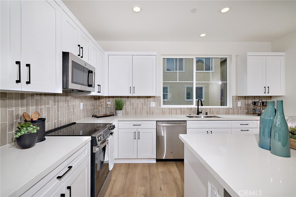 New Lower Price – Act Fast! Experience the perfect harmony of comfort and style in this beautifully designed three-story home. The first floor offers a flexible living space, a spacious two-car garage, and a welcoming porch entry. On the second floor, an open-concept design seamlessly connects the modern kitchen—complete with an island and pantry—to a generous dining area and a bright great room that extends to a private deck. A convenient powder room adds to the thoughtful layout. The third floor is a peaceful retreat, featuring a primary suite with a walk-in closet and en-suite bath, two additional bedrooms with ample storage, a second full bath, and a laundry area. Designed for modern living, this home blends functionality with contemporary elegance. Eastvale Square offers resort-style amenities designed for relaxation and recreation. Picture yourself lounging by the sparkling pool, unwinding in the soothing spa after a workout in the state-of-the-art fitness center, or enjoying quality time at the inviting clubhouse. Kids will love the vibrant playground, while adults can gather around BBQ grills and cozy firepits for unforgettable evenings. Stroll through scenic paseos, enjoy picnics in lush green spaces, or let your furry friends play in the dedicated dog park. For sports enthusiasts, a half basketball court adds to the fun. Experience the perfect blend of adventure and tranquility in this dynamic community.