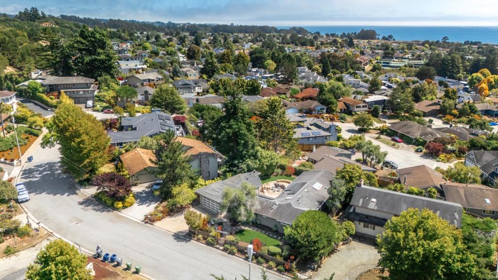 Perched above the Seascape neighborhoods of Aptos, this beautifully updated 3-bedroom, 3-bath home offers breathtaking ocean views and refined coastal living just minutes from the beach. Thoughtfully renovated with a blend of modern finishes, this home is designed to take full advantage of its idyllic surroundings. Step inside to find a bright, open-concept floor plan, where floor-to-ceiling windows frame views of the Pacific. The spacious living area features vaulted ceilings, fireplace, and engineered wood flooring, creating a warm, airy ambiance perfect for both entertaining and everyday living. The kitchen is a showstopper, fully remodeled with Caesarstone quartz countertops, custom cabinetry, a large island with bar seating, and high-end stainless appliancesall oriented to enjoy the coastal panorama. The main house features 3 bedrooms and 2 full baths, with the primary bath en-suite. The detached bonus room is perfect for your ocean view office or game room and comes with another full bath. Outside, enjoy the private landscaped backyard, ideal for entertaining or simply soaking in the sea breeze. Located in a peaceful neighborhood just minutes from miles of sandy beaches, the Seascape Resort and local shops and restaurants, this home offers the best Aptos has to offer.