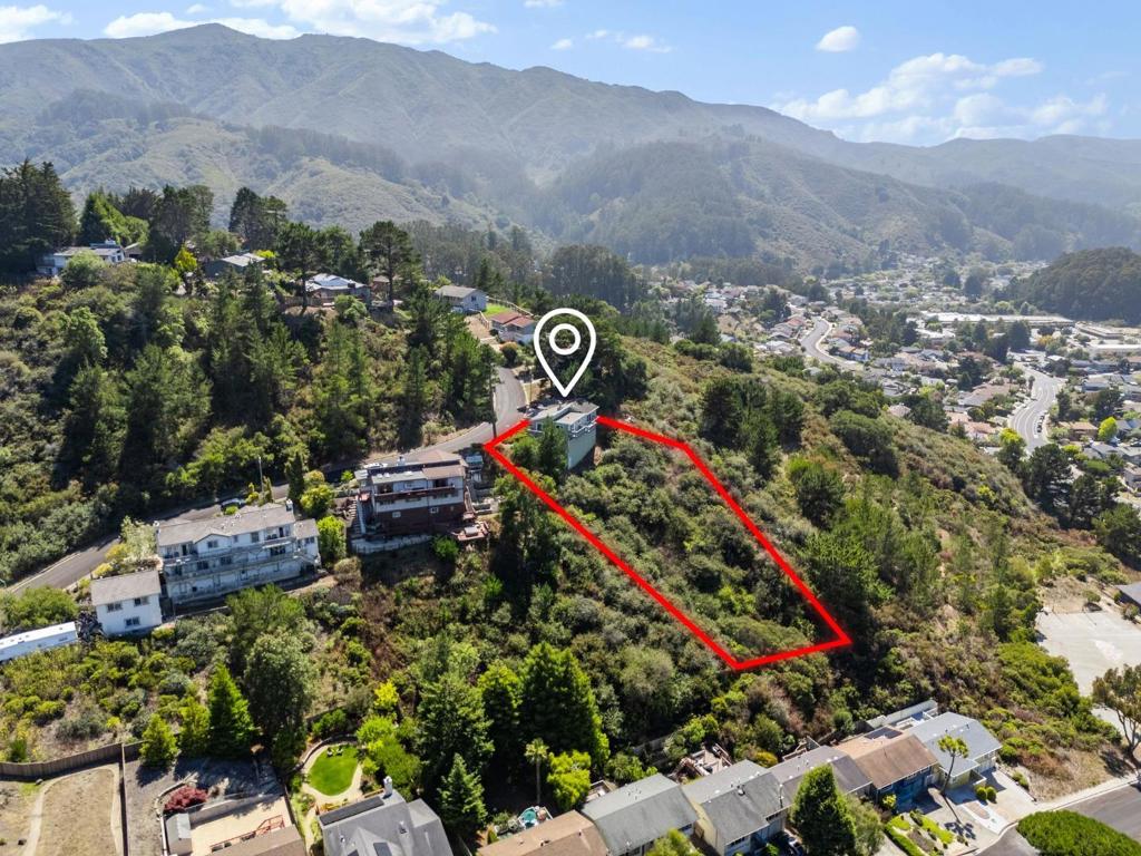 Welcome to your very own mountainside retreat. Tucked away in Pacificas sun-drenched Park Pacifica neighborhood amongst trees and hiking trails - and just minutes away from the beach -this is where serious Tahoe charm meet California coastal cool. Your huge lot, at over 0.8 acres, ensures it. Keep as-is or unwind on any of your large, mountain view decks and imagine all the dream possibilities a yard of this size creates. Step inside for hardwood floors, gorgeous vaulted ceilings, and incredible natural light throughout. The main floor is generously laid out with a spacious kitchen, living room, dining area, family room, and convenient half bath. Every detail comes together perfectly with expansive views, cozy gas fireplace, big windows and three glass slider doors to the decks, plus convenient interior access to the garage. Downstairs, the layout is equally as dreamy. Enjoy a primary suite with walk-in closet and spa-inspired bathroom, two additional bedrooms, another full bath, and flexible office/laundry/mudroom with direct outdoor access. Bonus: the massive unfinished basement space gives opportunity for future plans. At 9 Humboldt, here you are home! Note: Front yard image has been digitally enhanced to demonstrate possible landscaping improvements with artificial turf.