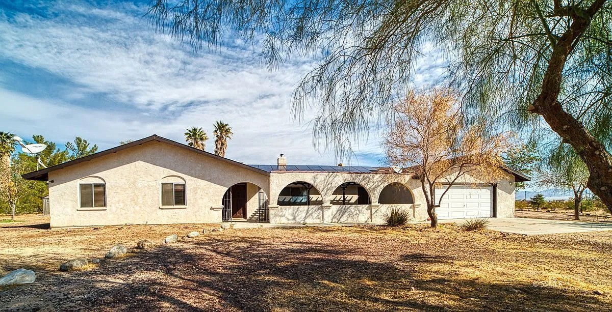 Short Sale – Priced to Move!
We are already in communication with the lender, and seller is cooperative. Home is being sold as-is.
Submit your highest and best offer – no blind offers. Buyer to verify all information.
The property is listed subject to lender approval.
Welcome to your own private slice of the high desert! This spacious 4-bedroom home sits on 5 fully fenced acres with an automatic gated entry — offering the ideal blend of comfort, functionality, and room to thrive.
Step inside to a warm and inviting layout featuring both a living room and family room, centered around a double-sided fireplace for cozy evenings. The master suite is a retreat of its own, complete with a pellet stove and a luxurious walk-in shower with dual shower heads.
The oversized kitchen is perfect for everyday living and entertaining — featuring a pantry, trash compactor, second sink, and all major appliances.
This property is built for those who love space and independence. You'll find:
A 720 sq ft attached garage, fully insulated
A huge 1,200 sq ft metal workshop, cooled and powered with a 200-amp panel, two 14' roll-up doors + one 10' door
A covered RV carport with power, plus two sea vans
A separately fenced garden area, ready for your homesteading dreams
The property runs on a shared well with a 5,000-gallon storage tank, and a pressure pump powered by PAID SOLAR (26 Hyundai 250-watt panels installed 10/2017).
Enjoy sweeping views in every direction, a large covered patio, and the peace of mind that comes with space, utility, and sustainability.