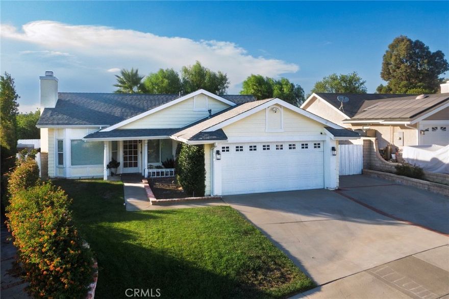 Tucked away in the desirable Mountain View West community of Saugus’ Bouquet Canyon area, this charming single-story home checks many boxes—No Mello Roos, No HOA, and a peaceful cul-de-sac location. A welcoming front porch leads to a 3-bedroom, 2-bath residence designed for comfort and everyday living. Inside, vaulted ceilings and a bay window brighten the living room, complete with a cozy fireplace. The adjacent formal dining room features a coffered ceiling, while the kitchen offers stainless steel appliances, a breakfast nook, and open flow into the family room—creating the perfect central gathering space. The primary suite includes mirrored wardrobes, a ceiling fan, backyard access, and a private bath with shower/tub combo. Two additional bedrooms share a full hall bath. Luxury vinyl flooring, copper re-pipe, faux wood blinds, newer A/C, windows, and exterior paint enhance the home’s appeal. Step outside to a spacious backyard with panoramic skies and mountain views. A solid covered patio with ceiling fan and string lighting sets the stage for year-round relaxation and entertaining, while a grassy lawn, planter beds, and dedicated RV parking make this backyard both functional and inviting. Additional highlights include a 2-car garage with storage cabinets, workbench, and laundry hookups, plus a Tesla charger and solar system. End your days with dazzling sunsets—this home delivers them in unforgettable fashion.