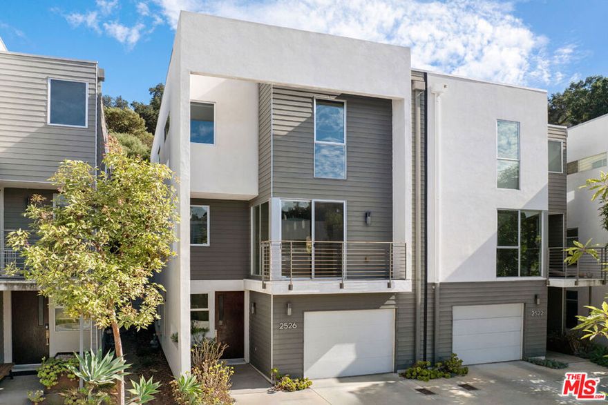 Stylish design and expansive space define this three-bedroom Modern in a quiet Echo Park enclave. The airy, earth-friendly home impresses with a generous layout spanning three levels, featuring a sunny great room with wood floors and glass sliders that open to a private yard, plus a versatile office space for work or guests. The open kitchen is appointed with quartz counters, a center island, and stainless appliances. Upstairs, three bedrooms include an oversized primary suite with walk-in closet, massive bath, and full laundry room. Enjoy central air, a two-car garage with direct access, and the ease of low-maintenance modern living. The setting feels private and tucked against a serene hillside, yet access is easy to Lady Byrd Cafe, Bacetti, The Semi-Tropic, Valerie, and the LA River Bike Path connecting to Frogtown and Elysian Valley trails.