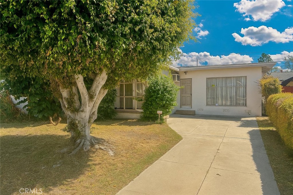 Welcome to this charming home within walking distance to restaurants, Target, Sprouts, and much more. This property features a living room that opens to a spacious family room, providing plenty of space for entertaining. A sliding door leads to the covered back patio, perfect for outdoor enjoyment. The home also offers a long driveway and a detached garage, adding convenience and functionality. While the home needs some TLC, it's excellent opportunity for buyers to add their personal touch. With its prime location and strong potential, this property is a great investment!
