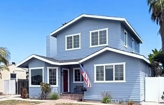 You want to be near the ocean—not just in theory, but in real life. You want breeze, light, and a little blue on the horizon. But you also want something with character that’s move-in ready, with an ocean view. Enter 2718 S. Averill. Tucked away on an ideal hidden street in Coastal San Pedro, this two-story home delivers original California charm, thoughtful space, and an ocean view from the upper level—all in a quiet neighborhood just blocks from the coast.
The main level welcomes you with a formal living room, brick fireplace, and a sunny bay window that captures the light and warmth of the day. Vintage hardwood floors run throughout the main living areas, connecting the open entertaining spaces. The farm-style kitchen features custom “Martha Stewart” finished rustic-style cabinetry, including elegant glass-panel doors, and a breakfast bar that opens to the dining room—perfect for morning coffee, weeknight dinners that don’t feel rushed, or for informal entertaining. Step right from the kitchen into a fenced backyard, where mature landscaping and quiet privacy offer space to unwind and gather. There’s room for gardening, entertaining large parties, dining al fresco, or dreaming up your future ADU (buyer to verify). Upstairs, the surprise bonus that sets this home apart: a second living space with a vaulted, beamed ceiling and a view of the Pacific Ocean and Catalina Island. Whether it becomes your creative studio, lounge, or workspace, this room has that rare top-of-the-hill clarity—both in light and in feeling. Downstairs includes three bedrooms with ceiling fans, a full bath and a 3/4 bath. One is a private primary suite, it's own bath and peaceful energy. Minutes from Point Fermin, Paseo del Mar, and the upcoming West Harbor development.