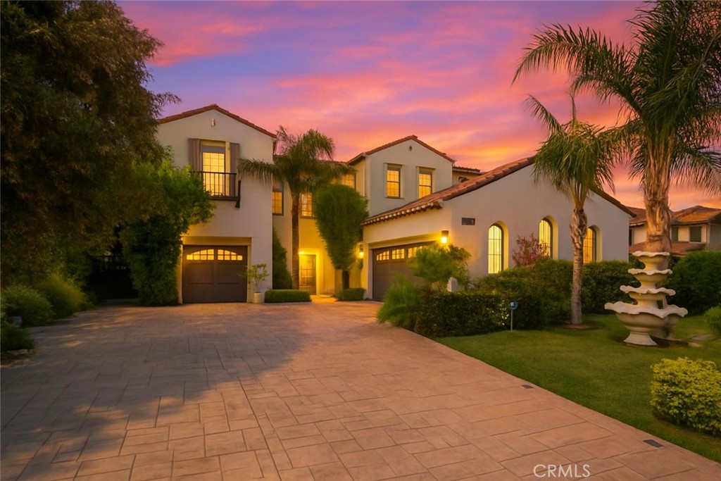 Welcome to 5231 Flora Court, a show-stopping residence tucked within the highly desirable gated community of Rancho Etiwanda Estates! Located at the end of a tranquil cul-de-sac, this stunning 5-bedroom, 4-bathroom home spans approx. 3,715 sq ft and sits on an expansive 8,865 sq ft lot. From the elegant stamped concrete driveway to the lush landscaping and dual fountains, every detail of the curb appeal is dialed in.
Step inside to find a blend of luxury and warmth, featuring rich dark wood and marble-look tile flooring, plantation shutters, and recessed lighting throughout. The gourmet kitchen has been fully remodeled with custom cabinetry, oversized quartz island, designer lighting, pot filler, walk-in pantry, and a pro-grade 8-burner range—perfect for entertainers and chefs alike.
Downstairs includes a full bedroom and bathroom, ideal for guests or multi-gen living. Upstairs, you’ll find a spacious loft, updated secondary bathrooms with modern tile work, and a grand primary suite featuring double-door entry, private balcony, and a luxurious en-suite bath with dual vanities, walk-in shower, soaking tub, and expansive walk-in closet.
The backyard is a true retreat—complete with a built-in fireplace, lush greenery, large patio space, and multiple seating areas for relaxing or entertaining under the stars.
Additional highlights include a 3-car split garage, dual fireplaces, butler’s pantry, and upstairs laundry room. This home is located in one of Rancho Cucamonga’s premier family-friendly neighborhoods, close to award-winning schools, parks, and Victoria Gardens.
Don’t miss your chance to own a turnkey gem in one of the most sought-after gated communities in the city!