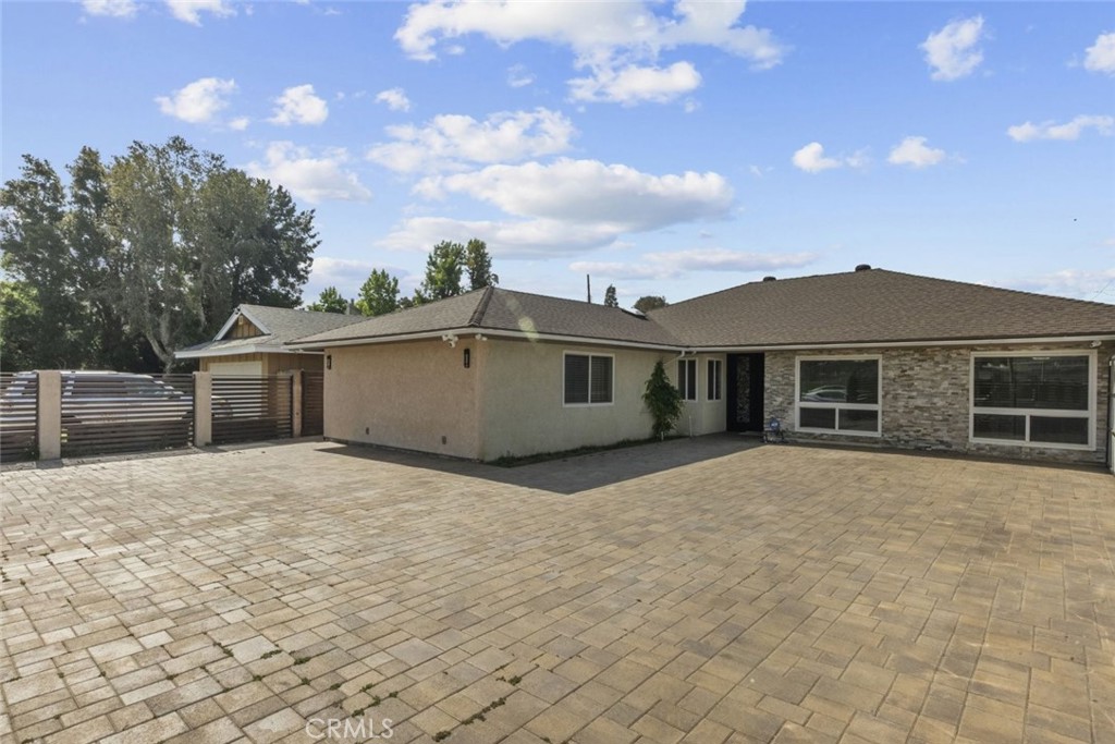 Beautifully situated in the heart of Chatsworth, this elegant 4-bedroom, 3-bathroom home is now available for lease. Thoughtfully designed with attention to detail, the interior features marbled tile flooring and recessed lighting throughout, creating a warm and refined ambiance. The spacious layout includes a full kitchen with a large center island, sleek countertops, ample cabinetry, and modern appliances, ideal for both everyday use and entertaining. Each bedroom offers generous space and comfort, with the primary suite featuring a private bath. The additional bathrooms are tastefully updated with quality finishes. Outside, the backyard is an ideal retreat with a covered open patio, recessed lighting, and a built-in fireplace, making it perfect for outdoor dining or relaxing. The property for rent is the main house. There is a junior ADU on-site that shares the same gated entrance. Please note, there is no garage. This Chatsworth home blends comfort, style, and convenience in a prime location.
