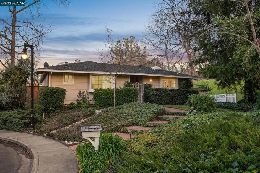 Absolute anomaly: Rare, well-laid out single level home on a cul-de-sac backing to a greenbelt. The curved brick pathway in the front guides you to the front door, with verdant mature trees shading the side & rear yards. Inside, natural light pours into every room from floor to ceiling windows & skylights, while real hardwood floors add warmth and elegance underfoot. You’ve been dreaming of this kitchen: the one that is the gathering spot for the holidays, with miles of cabinetry, elegant glass-front displays, a central island, built-in desk and stone countertops. Darling dining area just off the kitchen overlooks the rear patio. Living room is beyond comfortable: it is immense, with vaulted ceilings, wood burning fireplace ideal and a lovely view of the backyard. Cozy, primary retreat overlooks the front yard & greenbelt and is complete with ensuite bathroom & 2 closets including a spacious walk-in. Indoor laundry with washer & dryer + a 2 car finished garage round this home off as the ideal home. Backyard is charming & tidy with handsome deck and views of the park. The beloved neighborhood of Diablo West offers so many amenities: trails, pool, park, playground, tennis courts & a clubhouse. This move-in ready home is a unique find and an exciting opportunity.